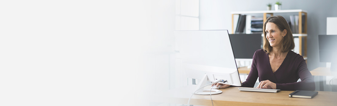 Woman working on a computer to build a custom website.