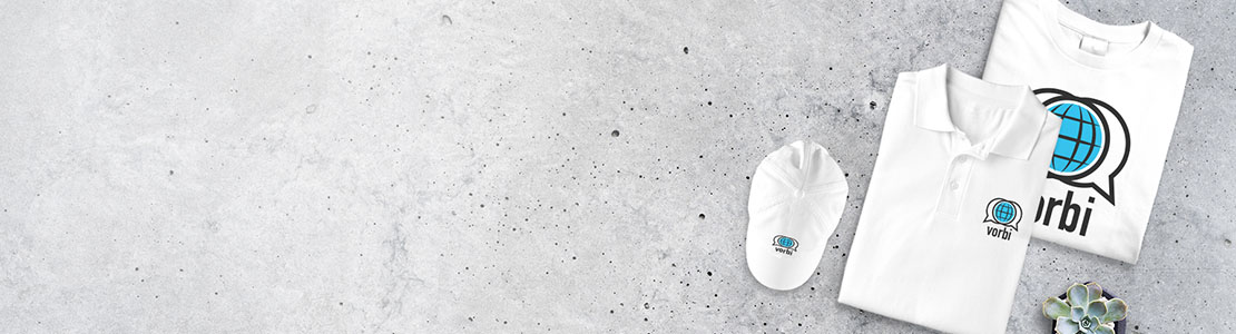 Personalized apparel including a custom baseball hat, polo, and tshirt laying on surface