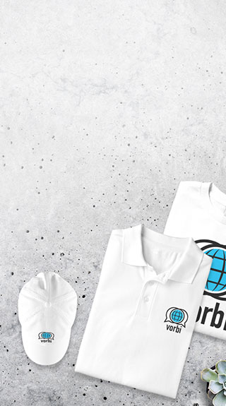 Personalized apparel including a custom baseball hat, polo, and tshirt laying on surface